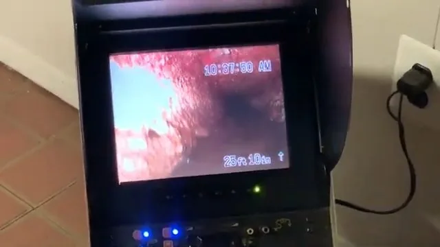 Sewer camera monitor showing the inside of a pipe with a timestamp and a distance counter on screen
